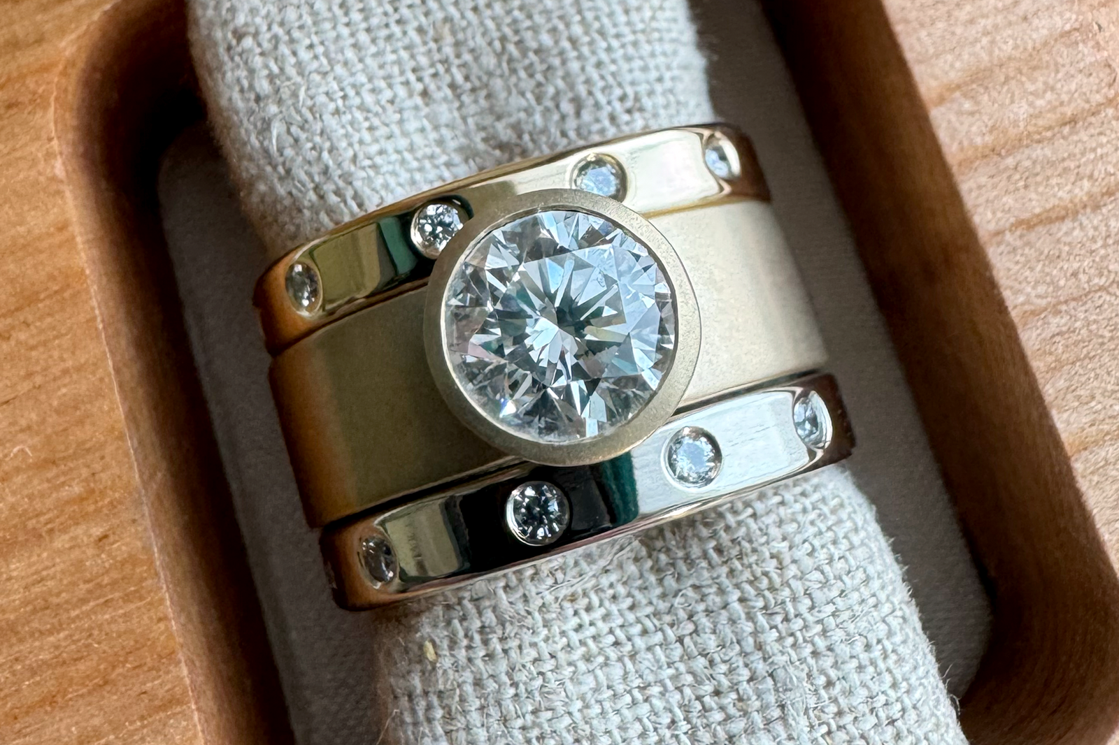 Custom mixed-metal Reconstruction ring stack featuring Becky’s original engagement diamond and wedding diamonds