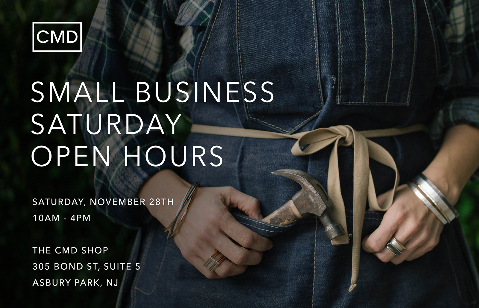 Colleen Mauer Designs Small Business Saturday Open Hours in Asbury Park, NJ, November 28, 2026, from 10am–4pm. Colleen wears a denim apron and handcrafted mixed-metal jewelry while holding a hammer.