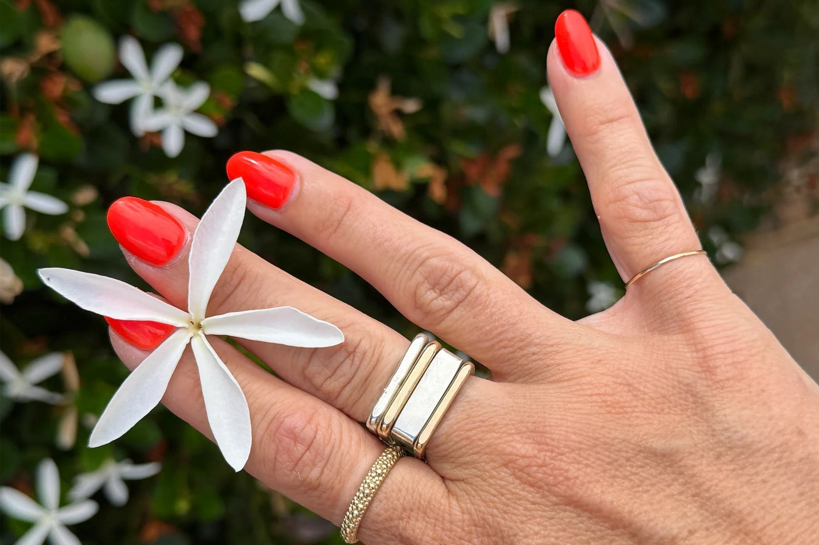 Colleen's signature mixed-metal Pinky Ring Stack with red nails