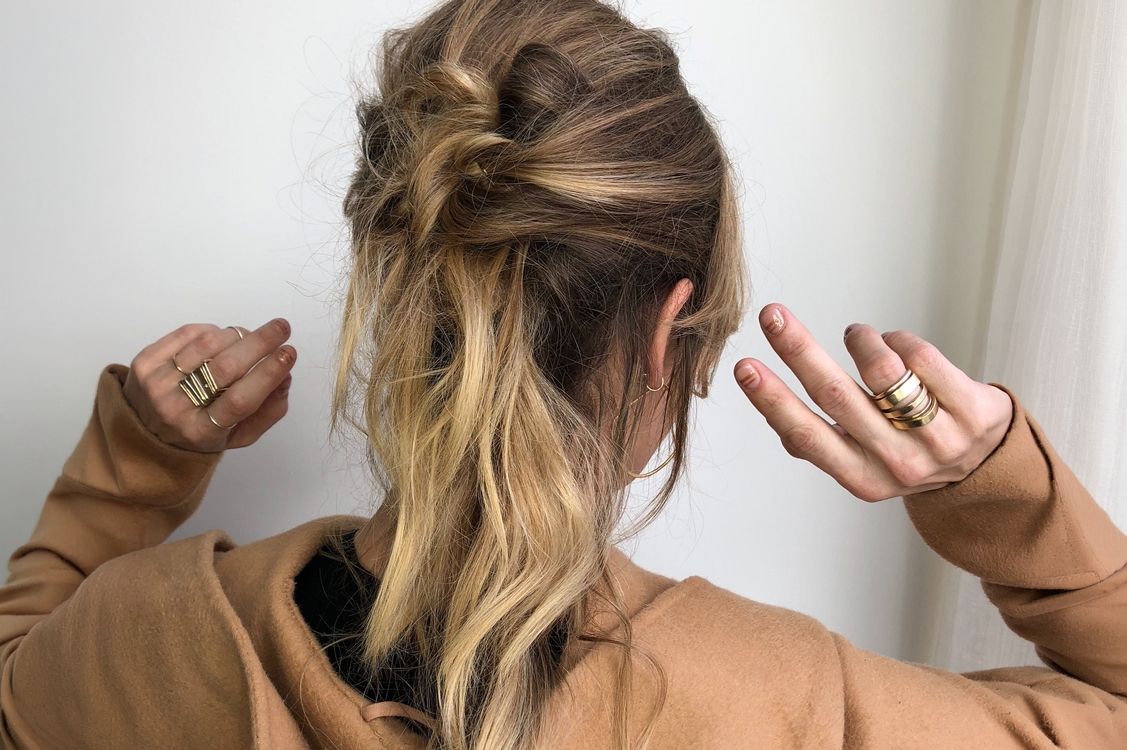 Colleen Mauer wearing mixed gold ring stacks on both hands