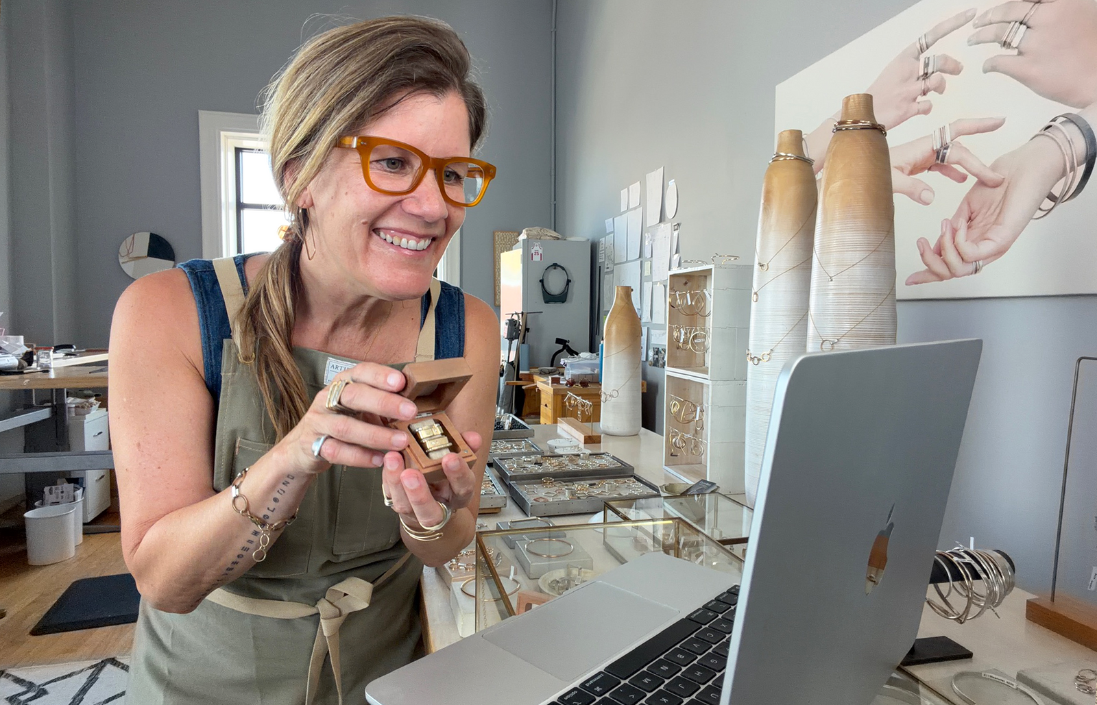 Colleen Mauer holding a custom jewelry set during a virtual design appointment at The CMD Shop in Asbury Park.
