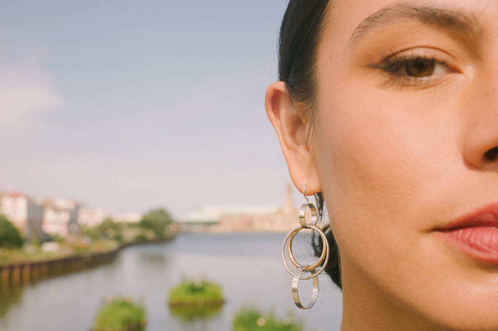 Model wearing mixed-metal CMD earrings on the Jersey Shore