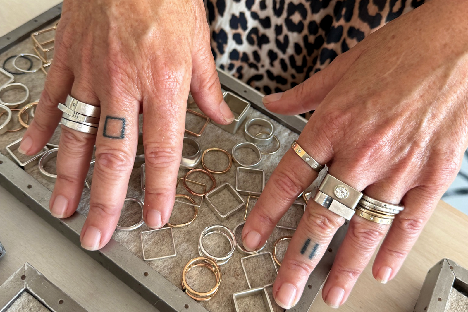 Robin showing her ring stacks at the CMD Shop & Studio in Asbury Park